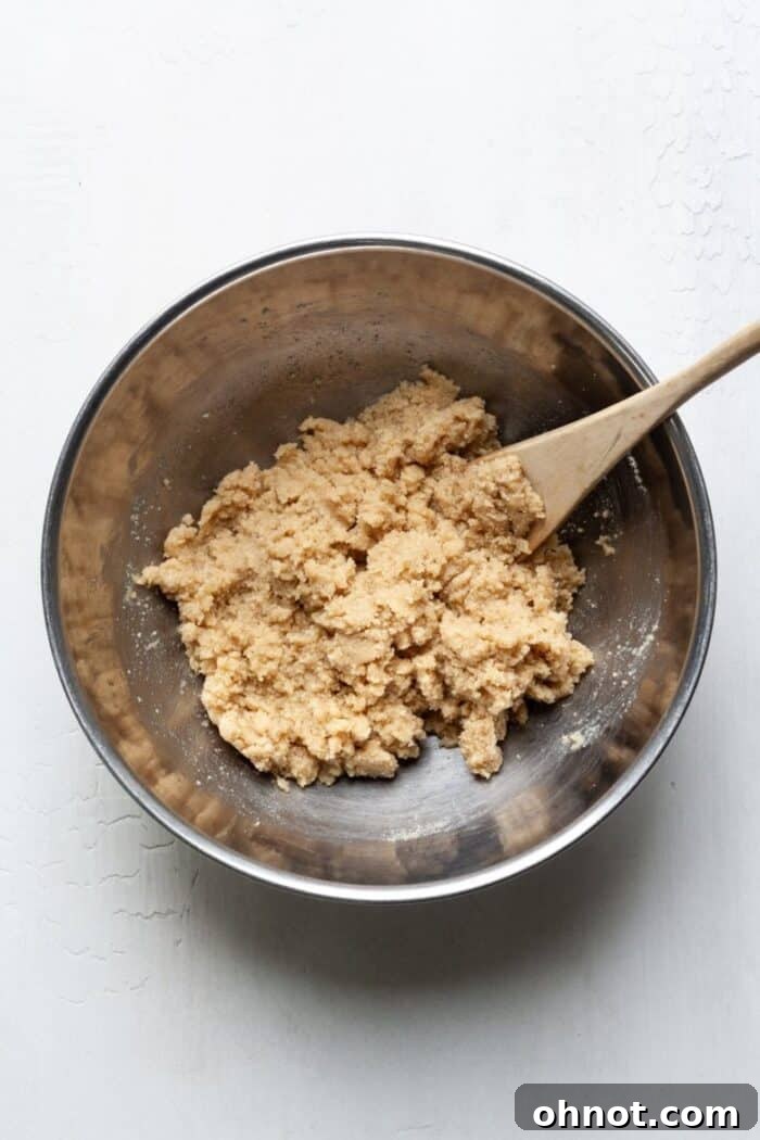 Almond flour thumbprint cookie dough in a mixing bowl, showing its soft and pliable texture before shaping.