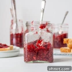A jar filled with Sugar free jelly made from raspberries and chia seeds.