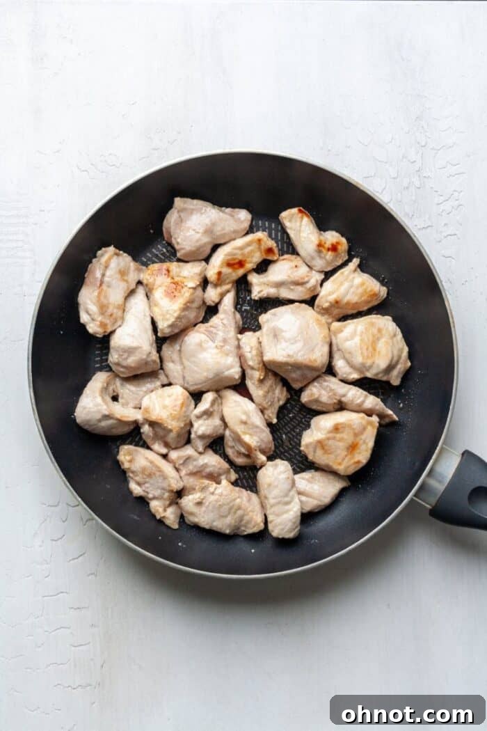 Lamb stew meat in a skillet.