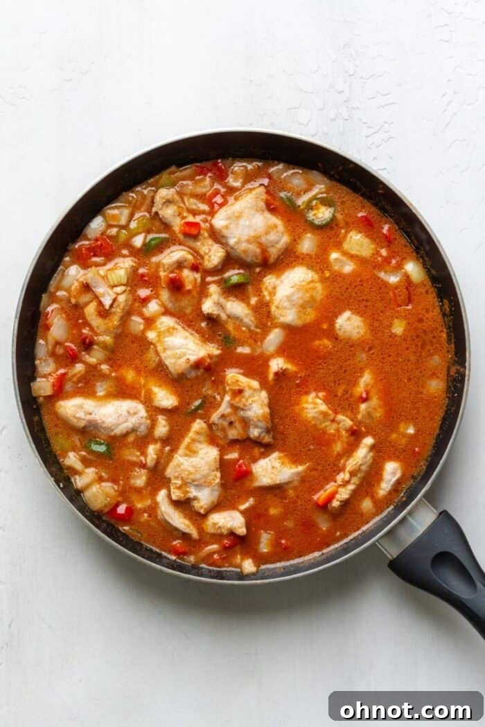 A skillet filled with meat and sauce