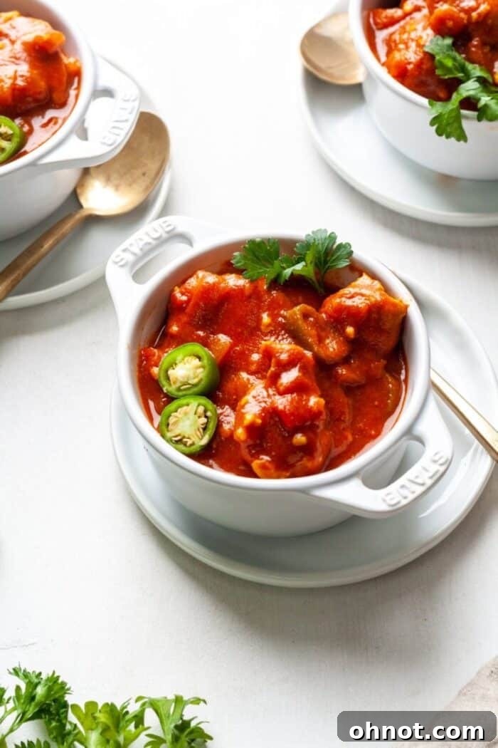 Lamb vindaloo in a white bowl.