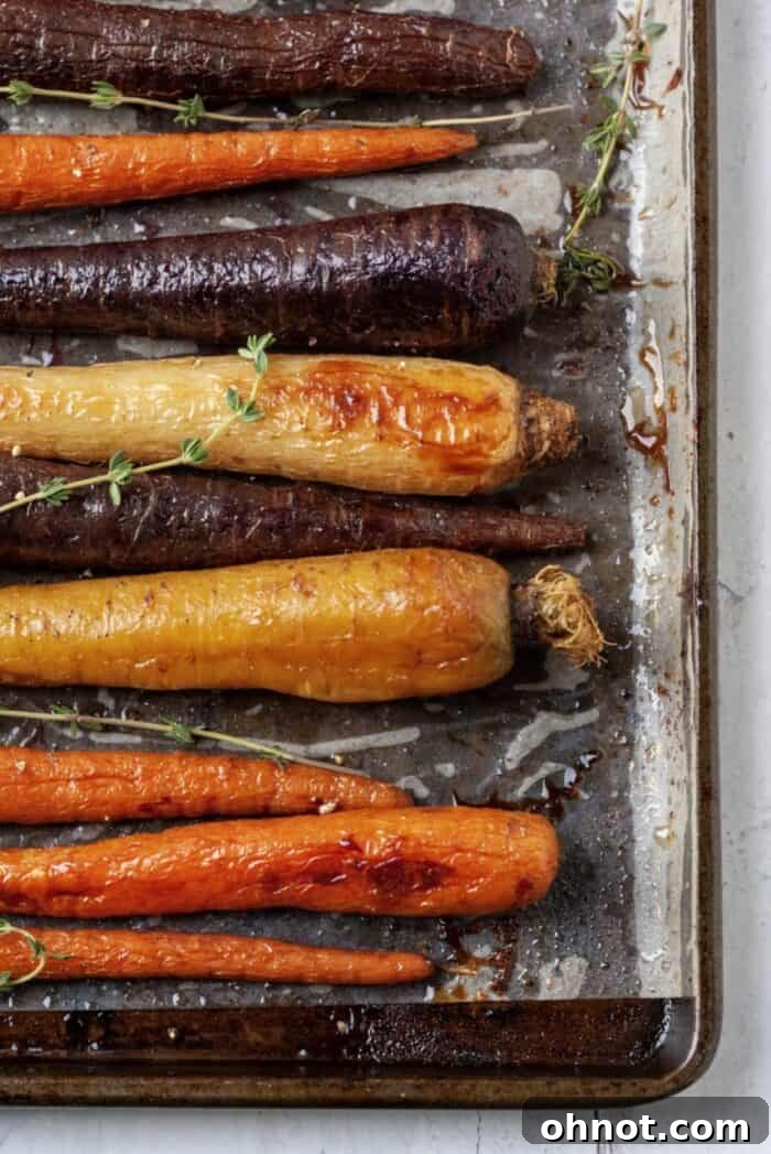 Air fryer carrots seasoned and ready on a baking sheet.