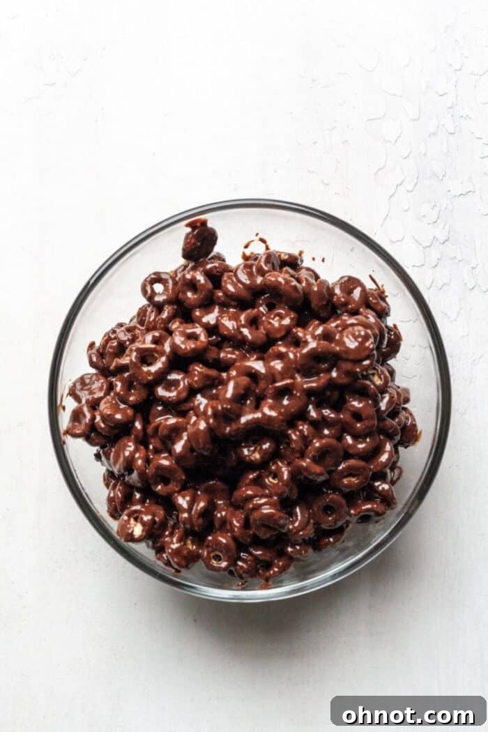 Paleo cereal fully covered in melted dark chocolate and almond butter, ready for the next step.