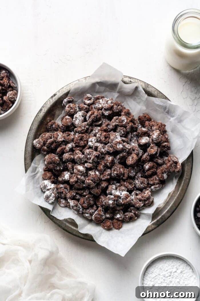 Muddy buddies in a rustic tin bowl, showcasing their powdery coating.