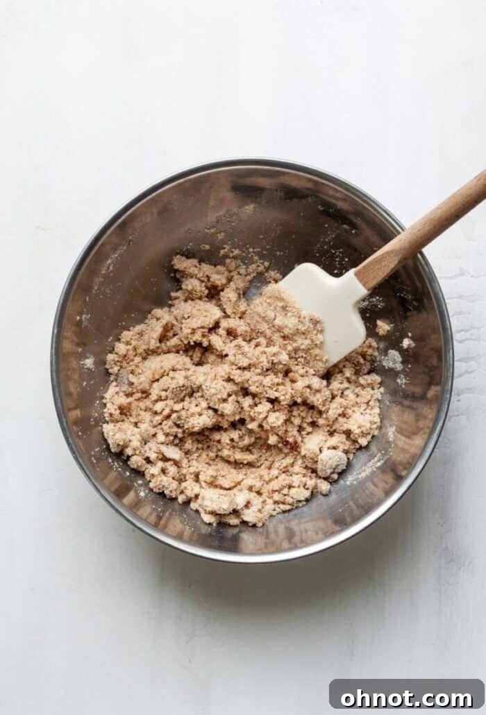 A bowl filled with the prepared gluten-free fruit crumble dough, showing its perfect crumbly texture.