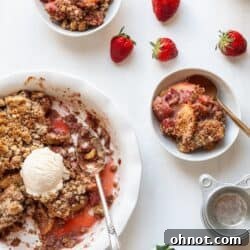 Gluten free apple strawberry crumble on a white backdrop.