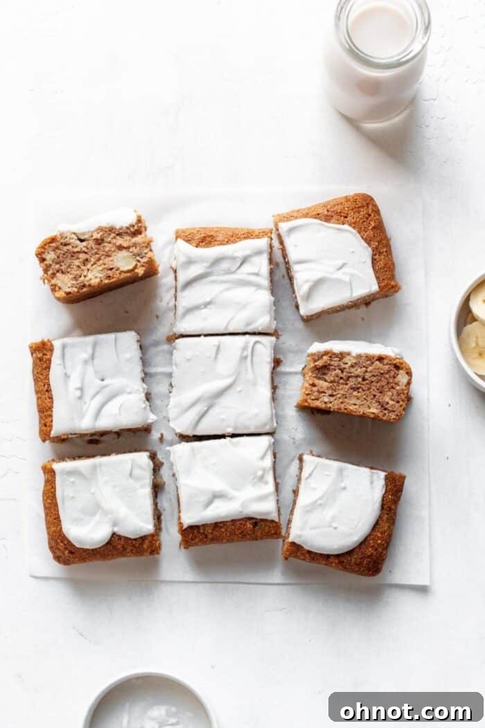 A beautifully sliced banana cake with a glass of milk, ready to be enjoyed.