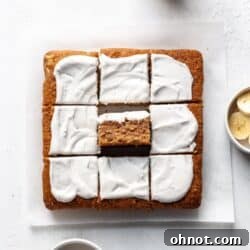 A gluten free banana cake on a white backdrop, elegantly frosted.