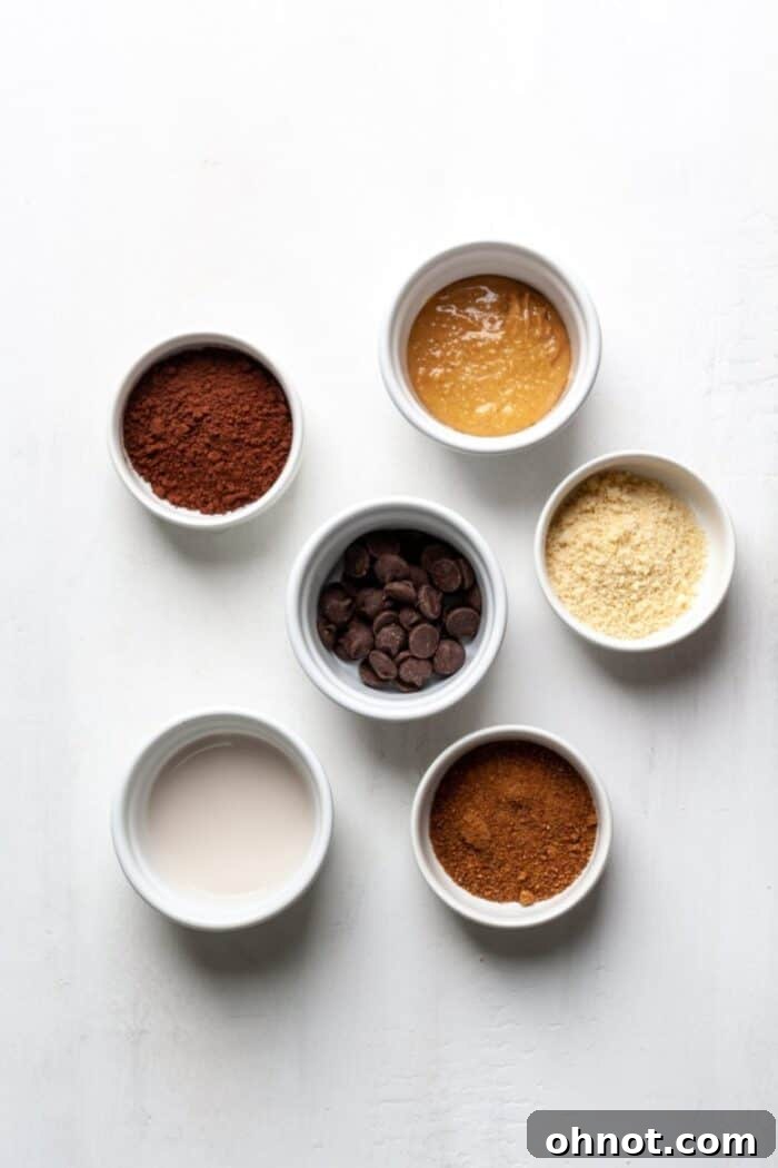 Assortment of baking ingredients for a brownie, laid out on a clean surface.