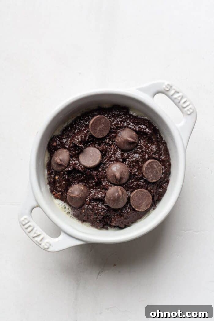 A mug with brownie batter inside, ready for the microwave.