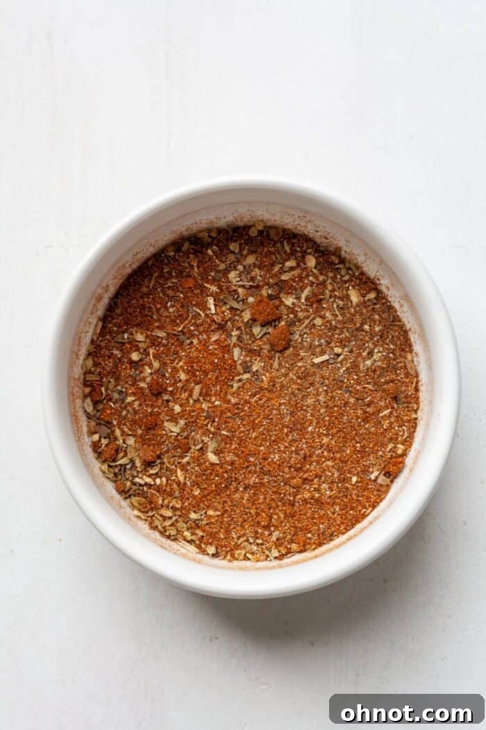 Homemade Cajun seasoning in a small ramekin, ready for use.