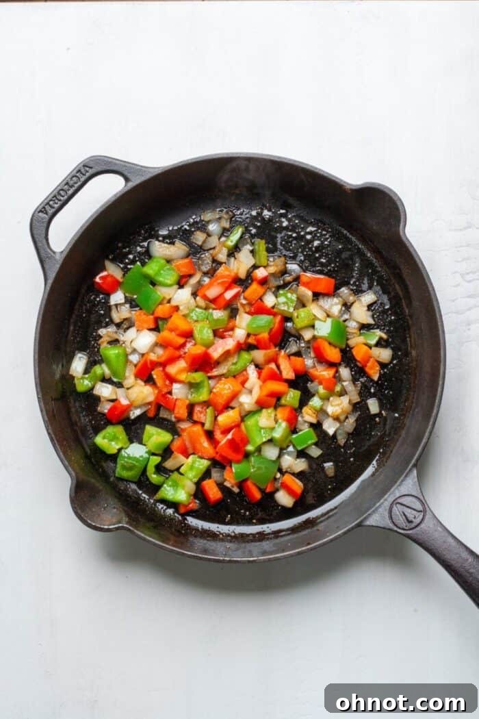 Onions and peppers in a cast iron skillet