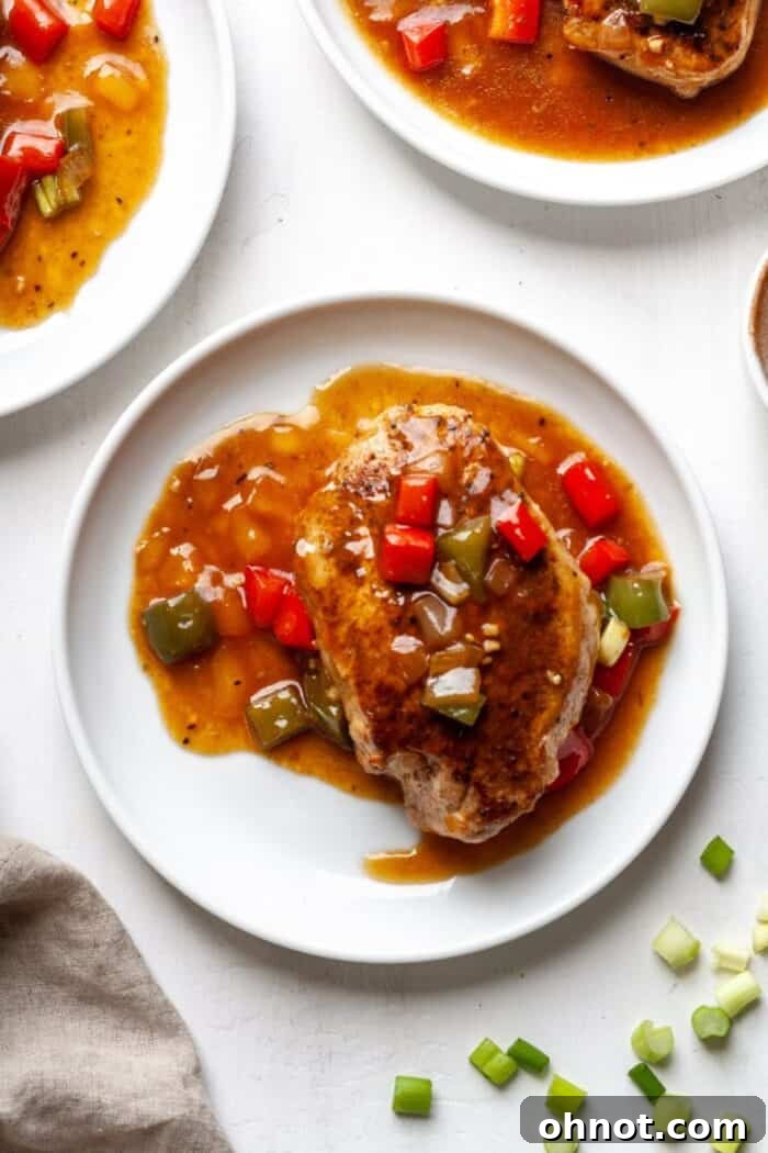 Cajun smothered pork chops on a white plate