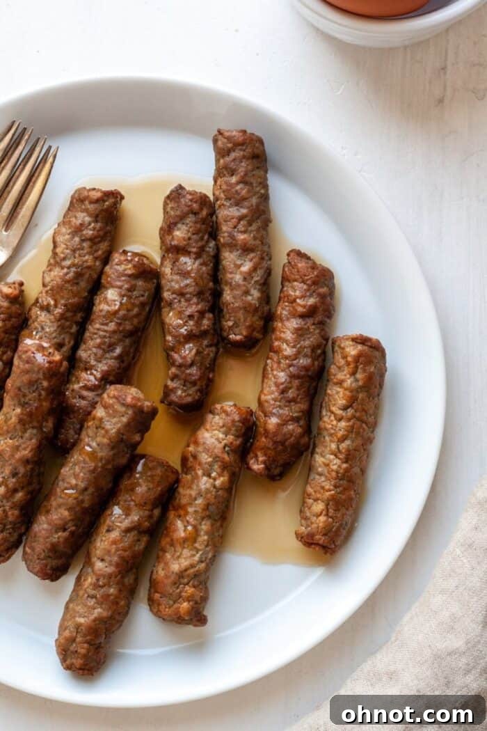 Whole30 sausage links on a white plate