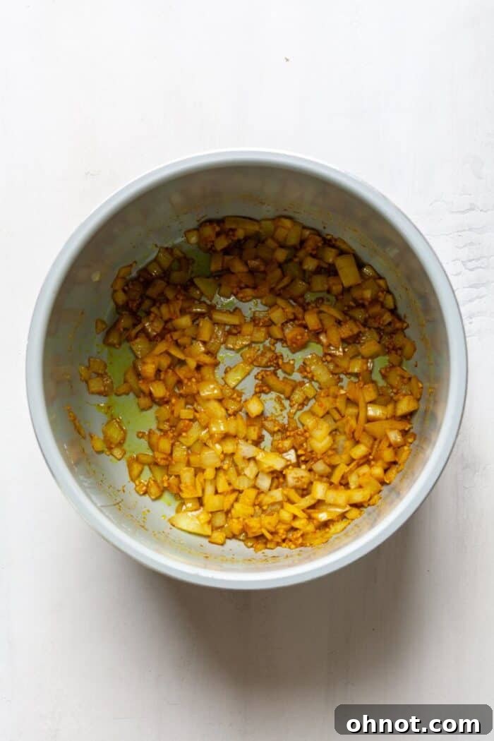 Finely diced onions and spices sautéing in an Instant Pot