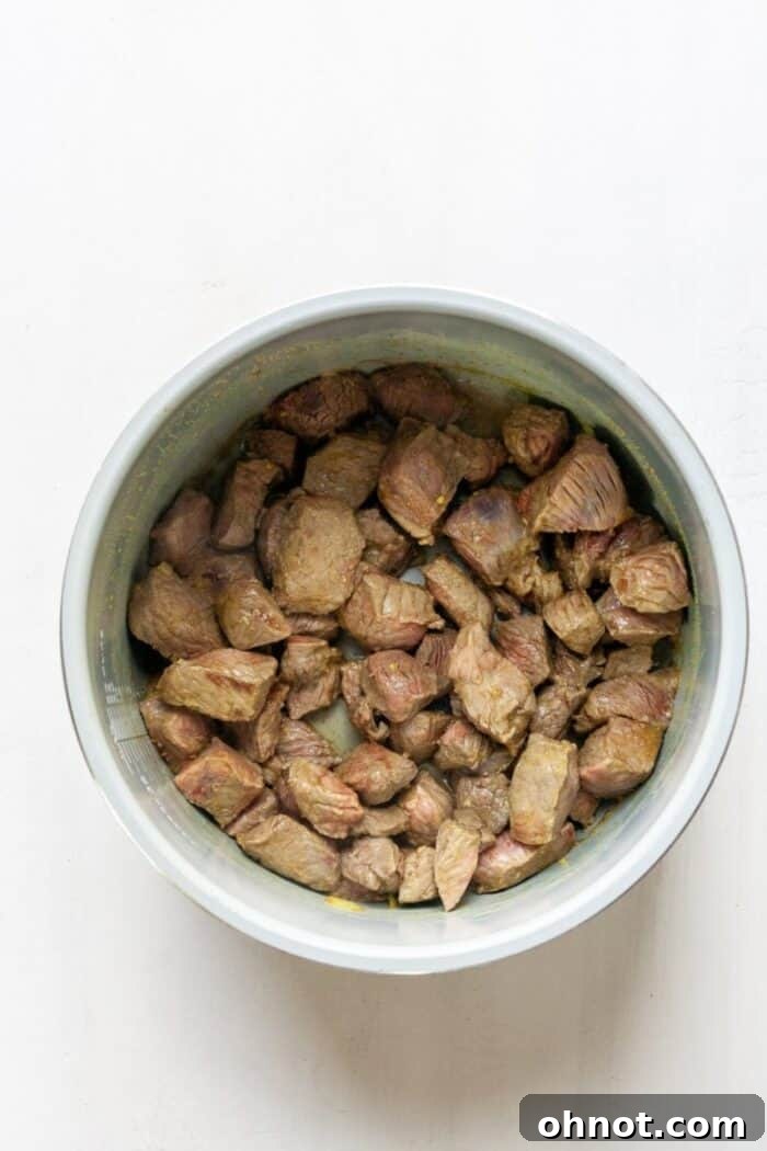 Cubed beef stew meat browning in an Instant Pot