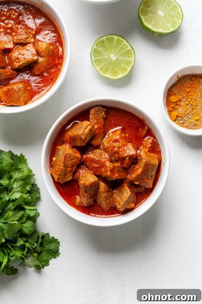Finished Beef Masala Curry in a white bowl, topped with fresh cilantro