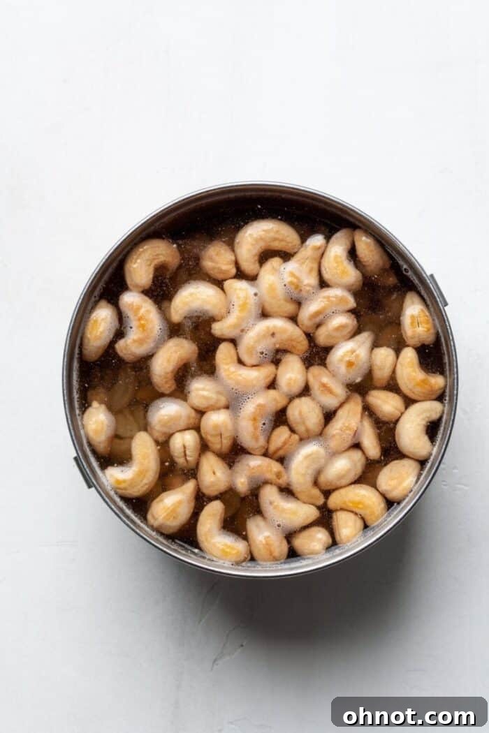 Cashews soaking in hot water, preparing for blending