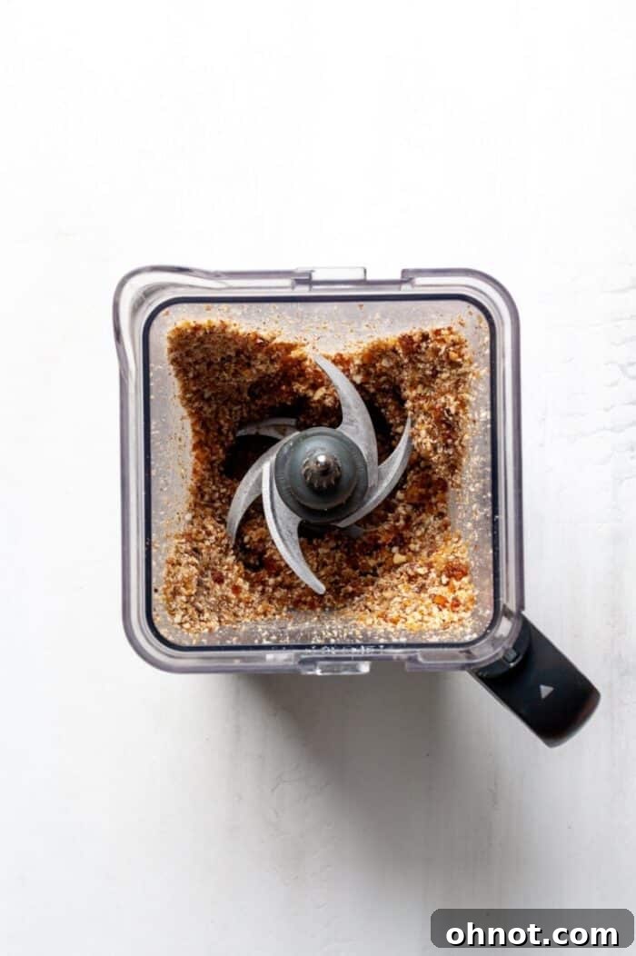 Finely blended cheesecake crust mixture in a food processor