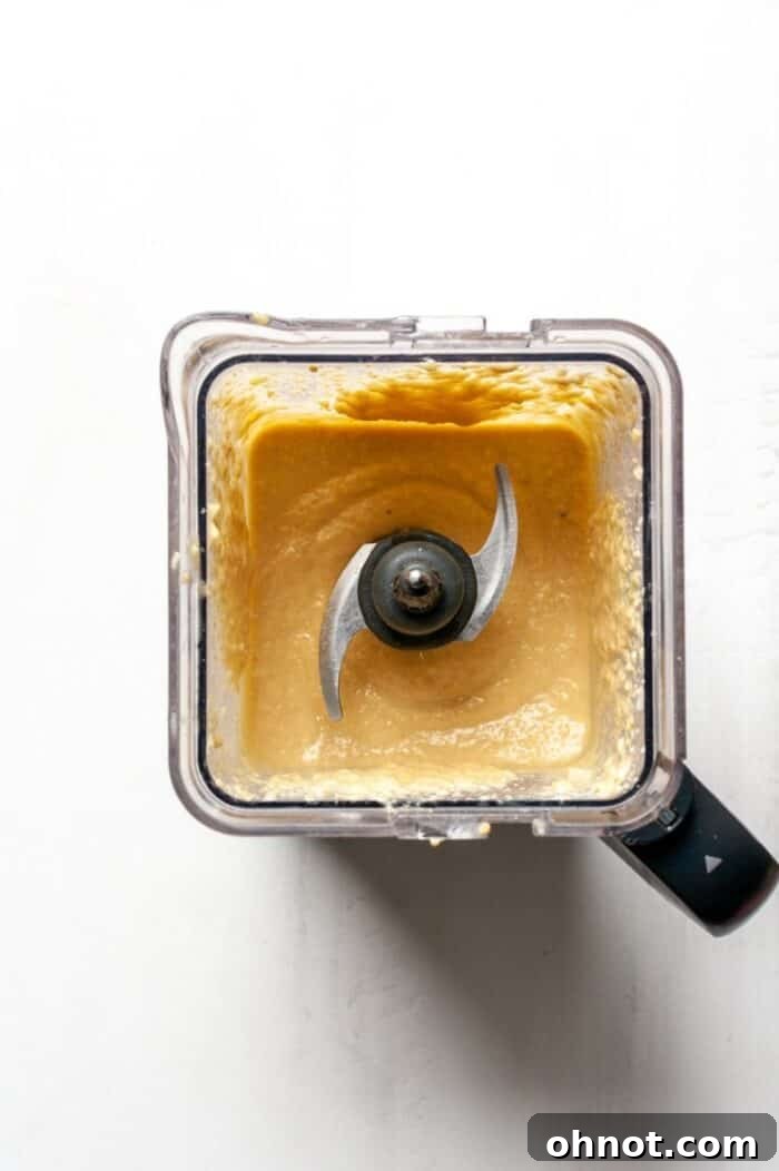 Smooth vegan mango cheesecake filling blending in a high-speed blender