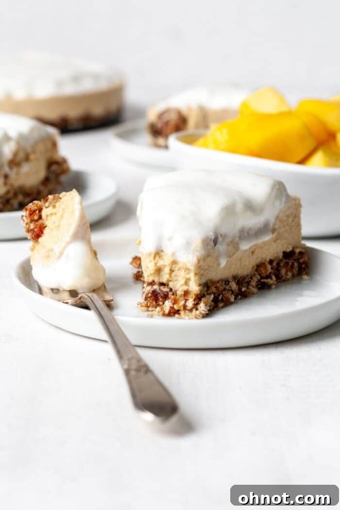 Healthy vegan mango cheesecake slice with a fork
