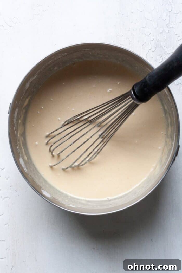 Smooth grain-free waffle batter in a mixing bowl, ready to be poured into the waffle maker.