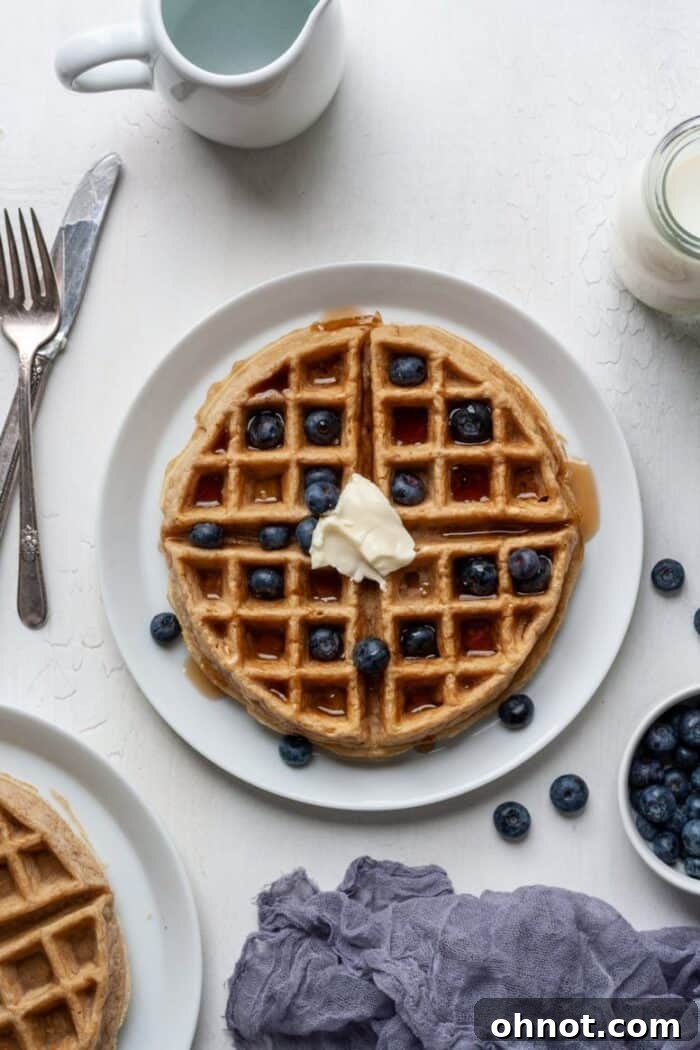 Fluffy cassava flour waffles generously topped with fresh blueberries, ready to be enjoyed.