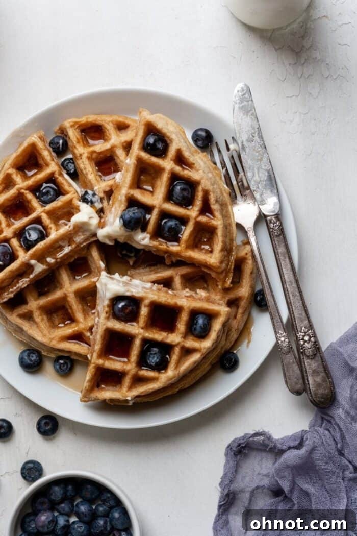 A stack of fluffy grain-free cassava flour waffles, ready to be served.