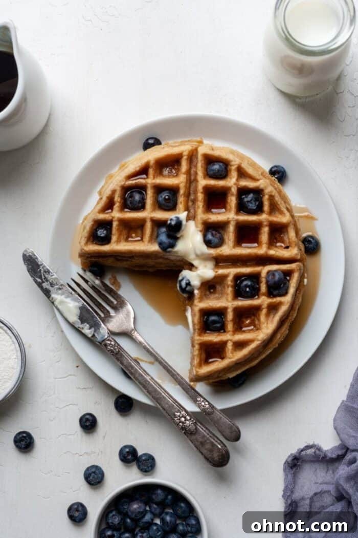 Beautifully textured cassava flour waffles with blueberries, perfectly golden and inviting.