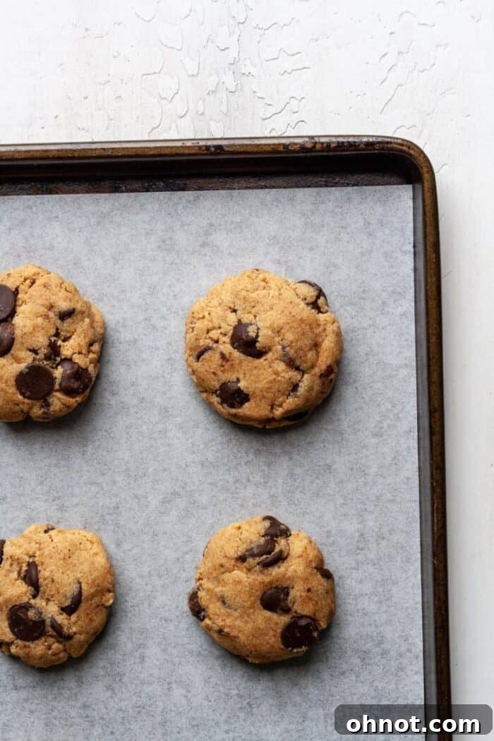 Paleo cookie dough balls on a parchment-lined baking sheet