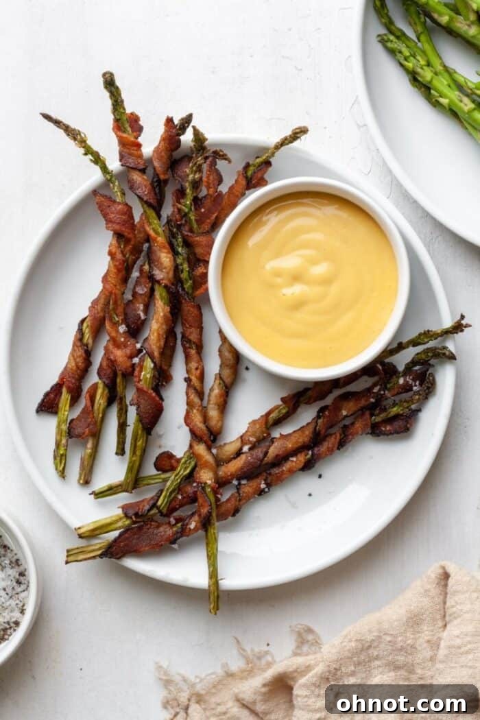 Bacon wrapped asparagus on a white plate