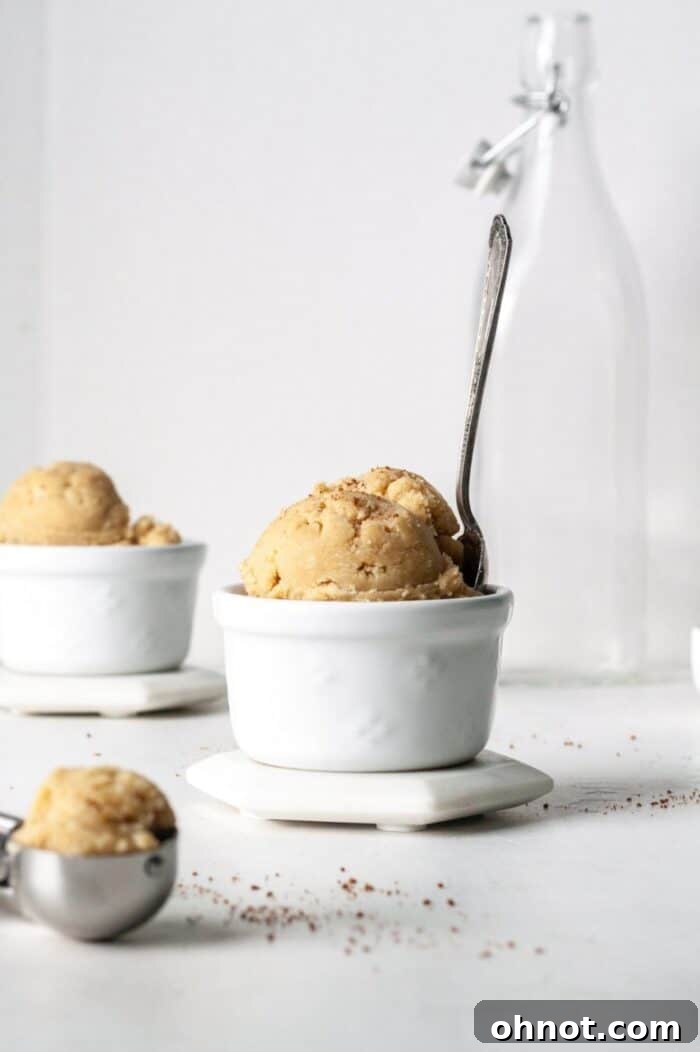 Stacked edible vegan snickerdoodle dough balls in a glass jar, perfectly portioned and ready for snacking