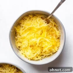 Air fryer spaghetti squash in a gray bowl with spoon