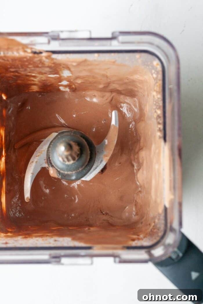 Blender with a rich, creamy chocolate smoothie, indicating it's perfectly blended.