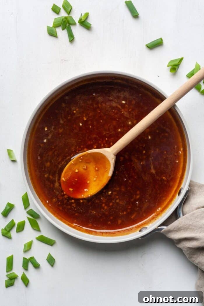 Stir fry sauce in white skillet with green onions