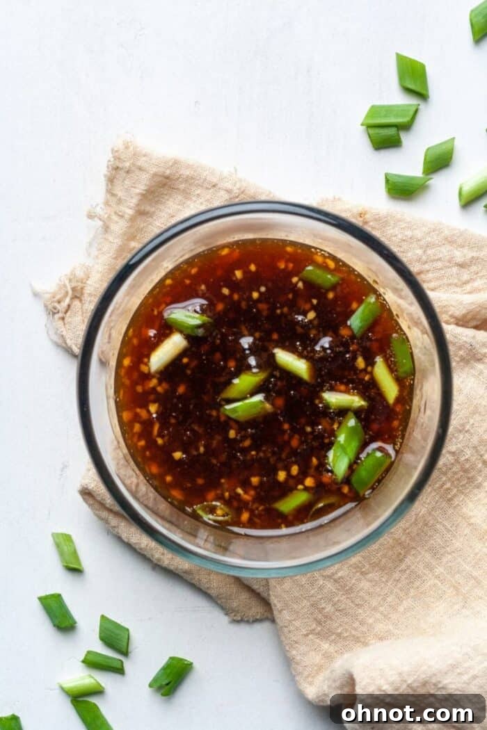 Sugar free stir fry sauce in glass bowl with green onions