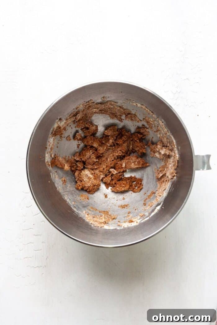 Softened butter and brown sugar creaming together in a stand mixer bowl.