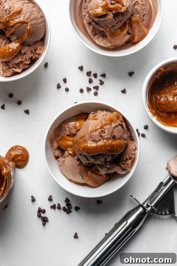A jar of vegan caramel sauce alongside a scoop of ice cream, illustrating its perfect use as a dessert topping.