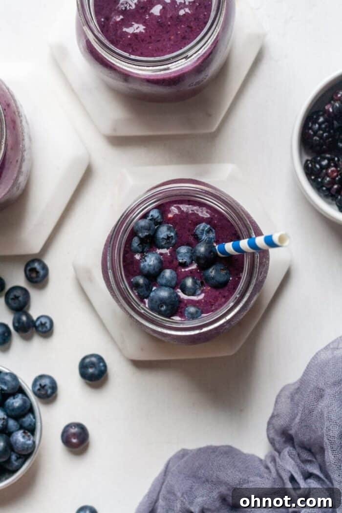 A refreshing Low FODMAP blueberry smoothie in a glass, ready to be enjoyed.