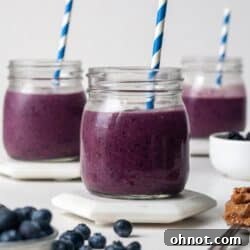 A vibrant blue smoothie with straws