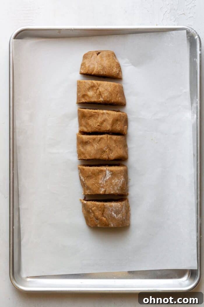 The fig newton dough log sliced into even 1-inch pieces before further shaping.