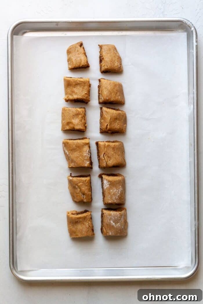Individual dough pieces for fig newtons, some already sliced in half for the final shape.