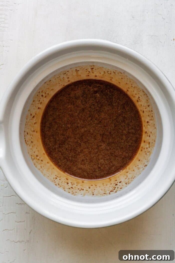 Mixing the wet ingredients for the gluten-free fig newton crust in a bowl.