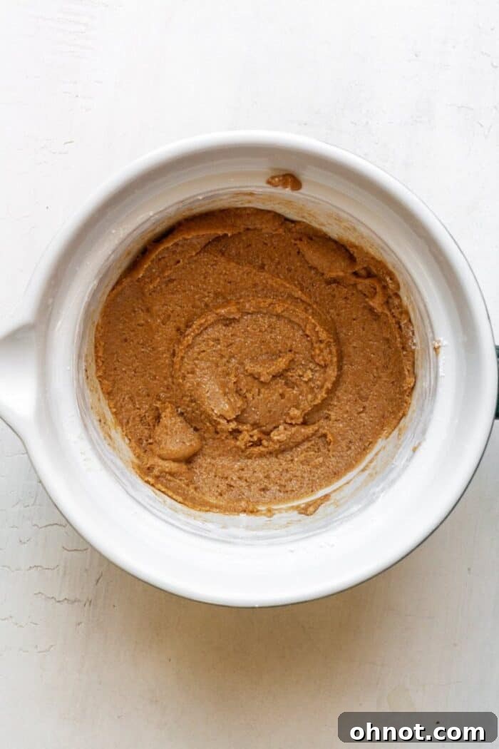 The combined crust batter in a white mixing bowl, smooth and ready to be formed.