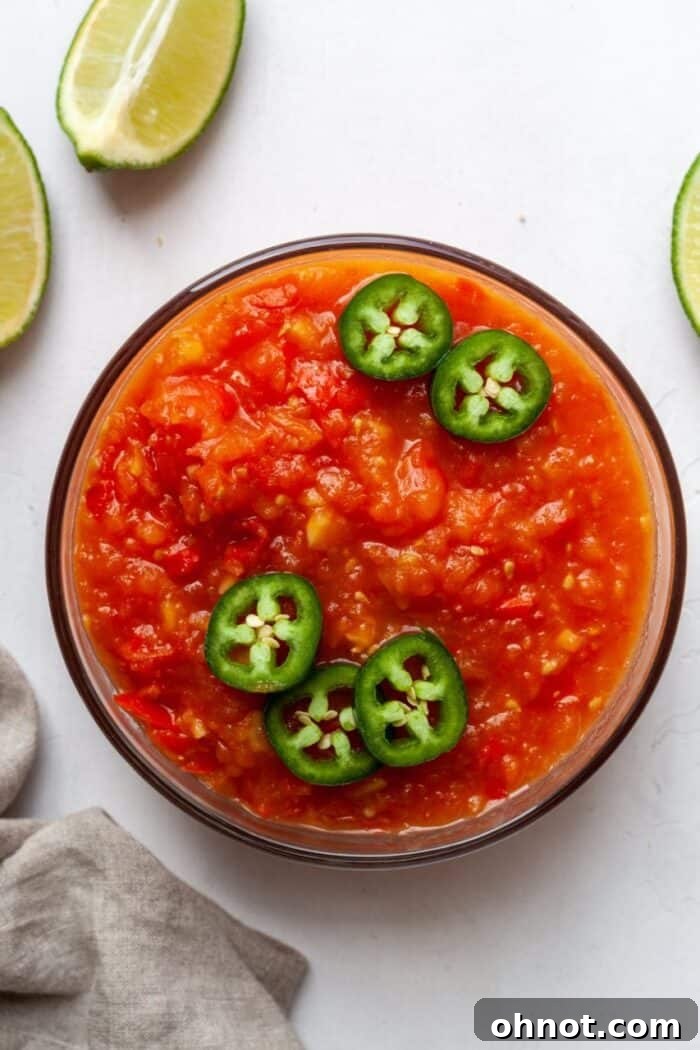 Mango habanero salsa in bowl with jalapeños