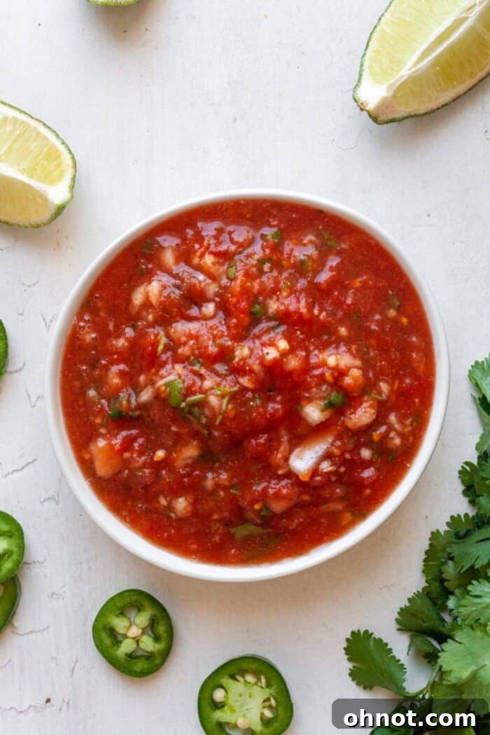 Keto salsa in a bowl garnished with a whole jalapeño