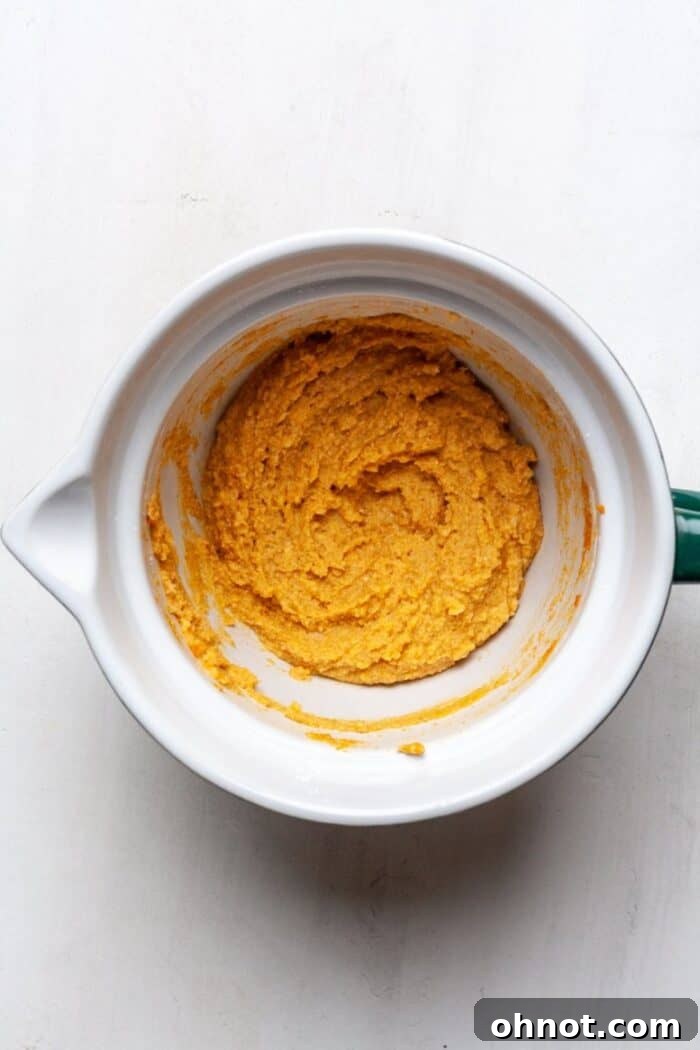 Smooth and thick pumpkin cookie batter in a mixing bowl