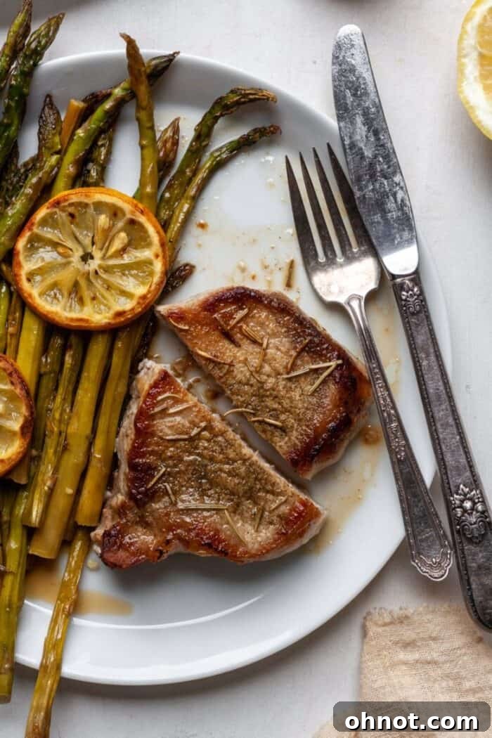 Plated AIP pork chops with green side dish and garnish