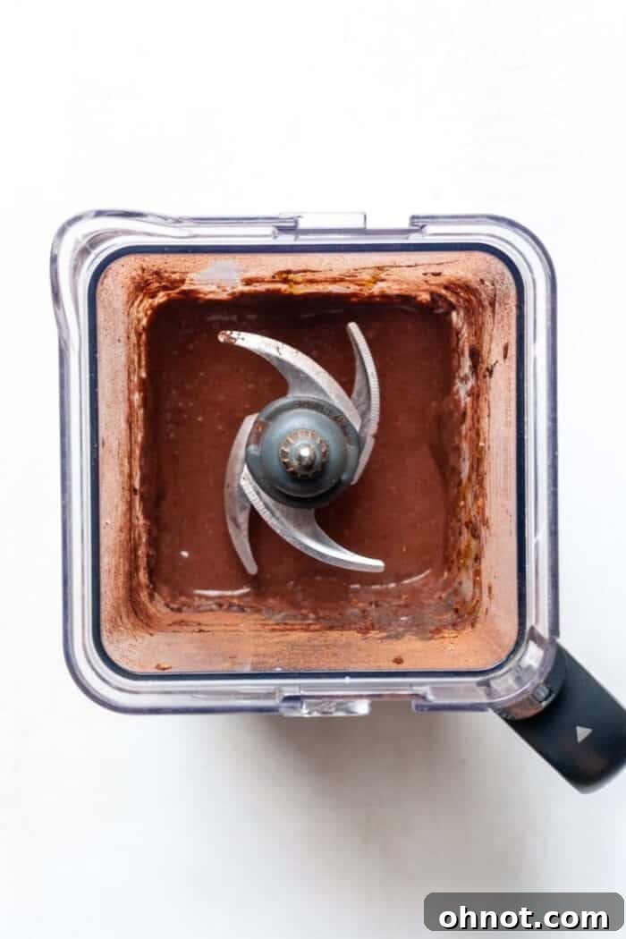 Smooth and creamy chocolate oatmeal batter in a blender after processing