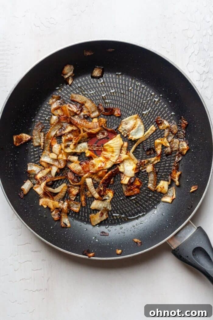 Caramelized onions in a skillet, softened and golden brown